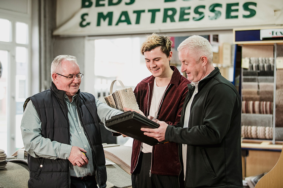 People discussing in front of beds and mattresses store